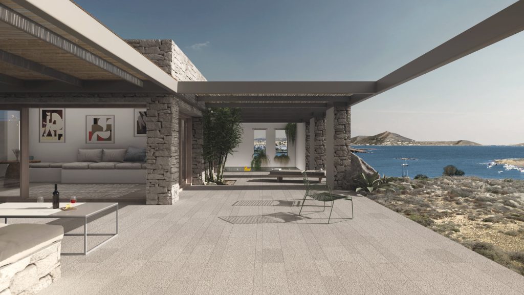 VISTAS-TERRAZA-MAR-REBEL-CAPYBARA Render exterior de gran terraza en villa moderna griega, con suelo de piedra abujardado, pergolas de aluminio y vistas al mar. Por Rebel Capybara Studio.